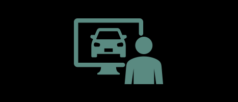 A sage-green minimalist icon on a black background showing a person standing next to a computer monitor that displays the front view of a car.