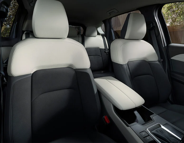 View from inside a car's driver's seat while driving through a tunnel at night, showing light trails.