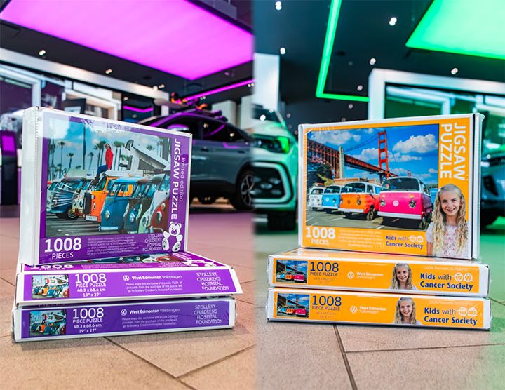 A split-screen image showing stacks of 1008-piece jigsaw puzzles. The left side shows purple boxes benefiting the Stollery Children’s Hospital Foundation; the right side shows yellow boxes benefiting the Kids with Cancer Society. Both puzzle designs feature colorful Volkswagen vans.