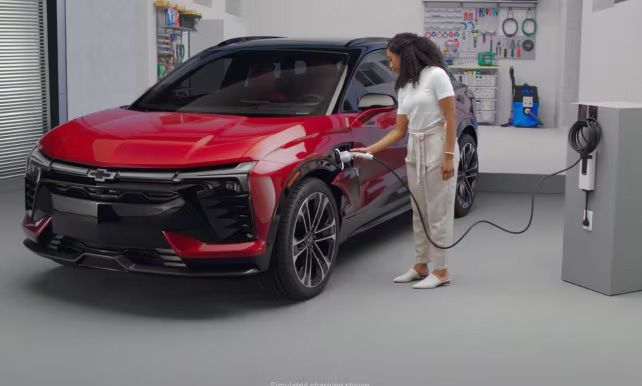 A person charging the 2025 Chevrolet Blazer EV indoors.