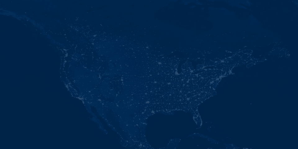 A dark blue map of North America at night, showing bright clusters of light representing major cities and infrastructure across the United States, southern Canada, and parts of Mexico.