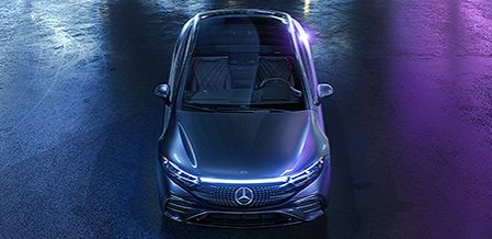 Top-down view of a Mercedes-Benz EQS under purple lighting