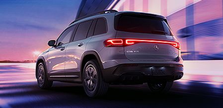 Rear view of a Mercedes-Benz GLB in motion at sunset