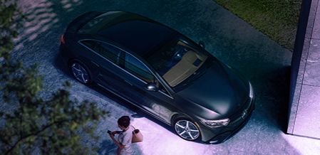 Aerial view of a black Mercedes-Benz parked near a building at night