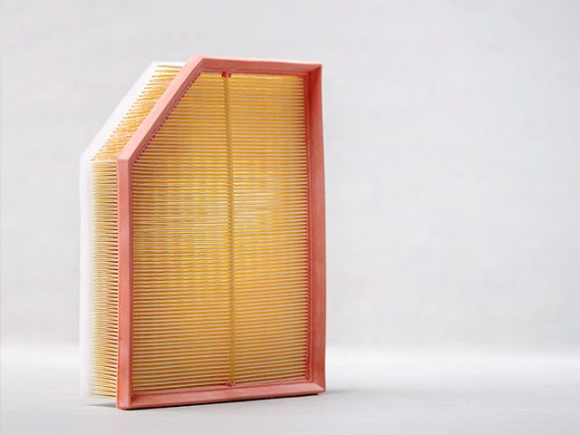A new, clean rectangular engine air filter with a pink frame and yellow pleated paper, shown against a plain background.