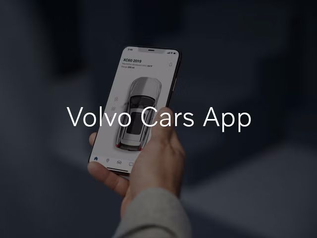 A person holds a smartphone displaying the Volvo Cars App, which shows the status of an XC60. The text "Volvo Cars App" is overlaid on the image.