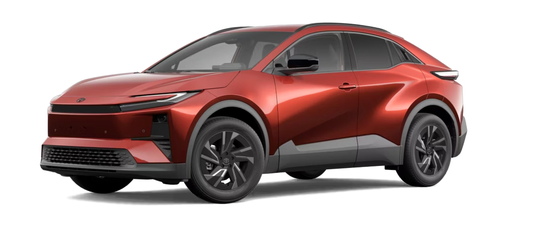 Studio shot of a bright red Toyota bZ4X, showing the front and side of the vehicle on a white background.