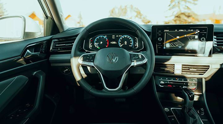 Interior cockpit view of the 2026 Volkswagen Jetta showing steering wheel, digital instrument cluster, and infotainment display.