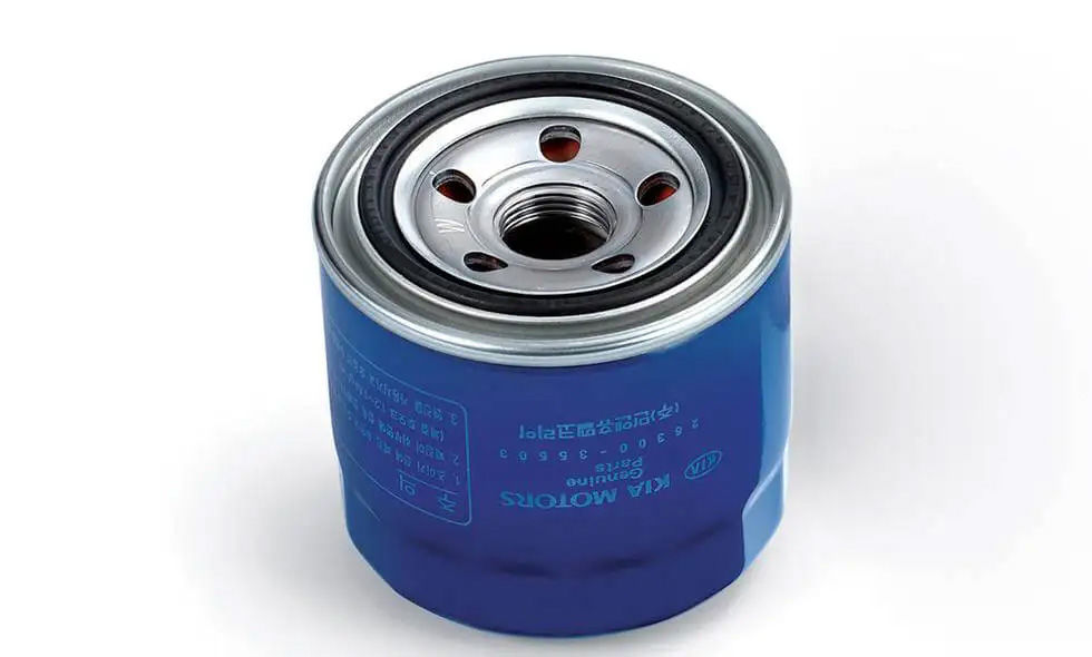 A blue Kia Motors Genuine Parts oil filter standing on a white surface.