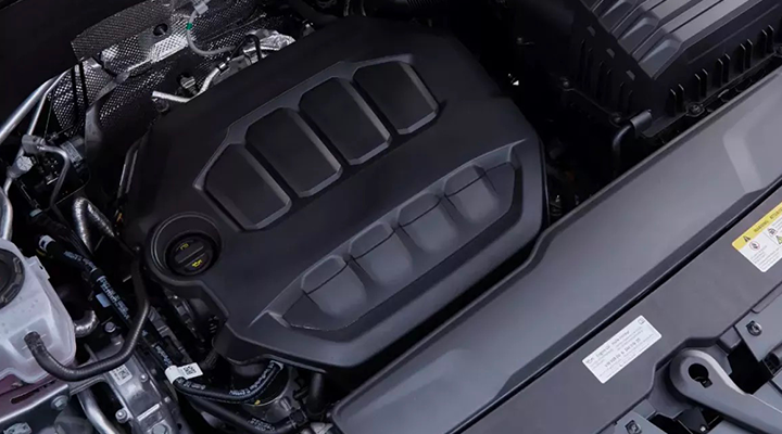 Close-up, overhead view of the engine cover under the hood of an SUV.