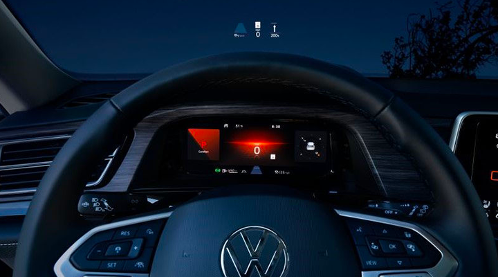 View from the driver's seat showing the steering wheel and dashboard, with information projected onto the windshield (Head-Up Display).