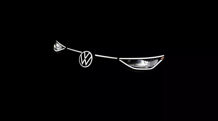Front view of a car's headlights and LED Illuminated Light Line illuminated against a black background.