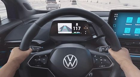 Close-up of a hand touching a car's touchscreen to accept an Over-the-Air Update notification.
