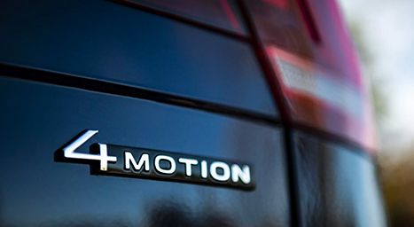 Close-up of the "4MOTION" badge on the rear of a dark car, indicating all-wheel drive.