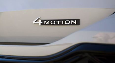Close-up of the "4MOTION" badge on the rear of a dark car, indicating all-wheel drive.