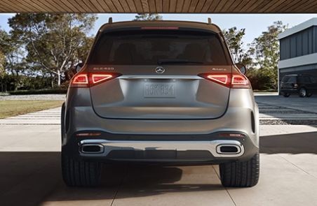 Rear view of a grey Mercedes-Benz GLE SUV parked under a carport.