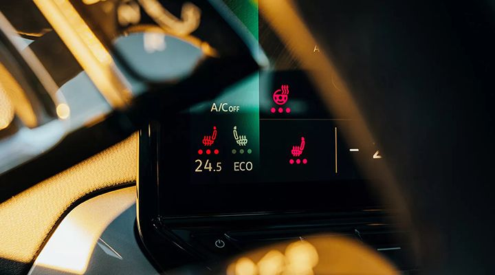 Close-up of the climate control screen showing red icons for the heated and ventilated seats feature.