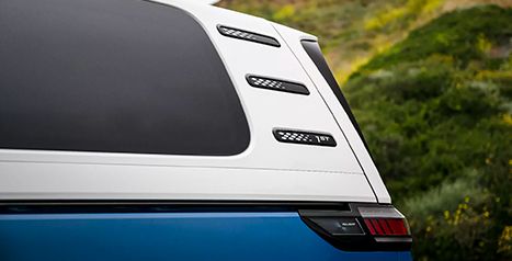 Close-up of the rear pillar vents and the two-tone paint (white over blue) of the Volkswagen ID. Buzz.