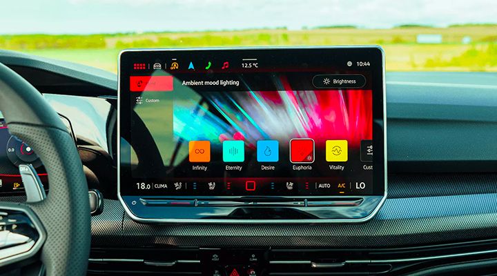 Close-up of the infotainment screen displaying the Ambient mood lighting settings with vivid color options.