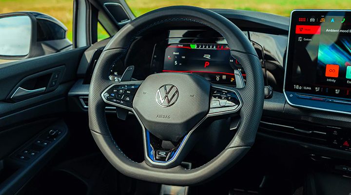 View of the sport steering wheel and digital dashboard displaying performance information in a Volkswagen Golf R.