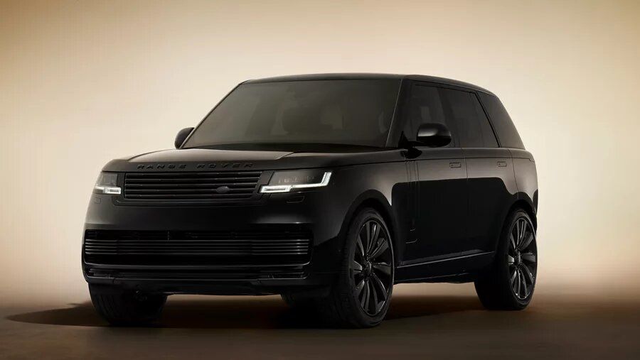Front view of an all-black Range Rover (Black Edition) in a dark studio.