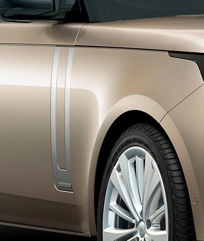 Close-up view of the wheel and silver side vent on a light bronze model.