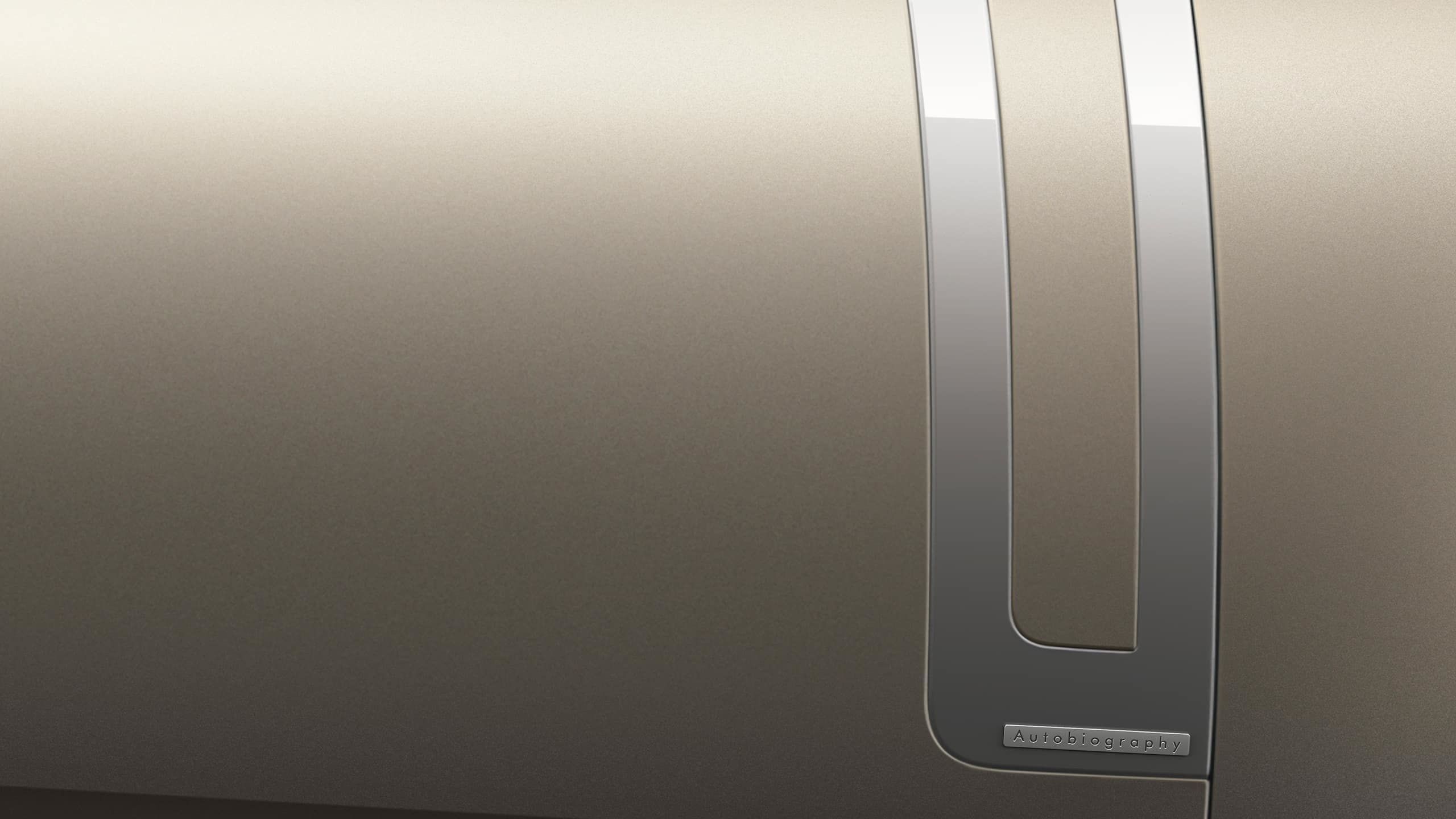 Close-up of the "Autobiography" badge and metallic trim on the car door.