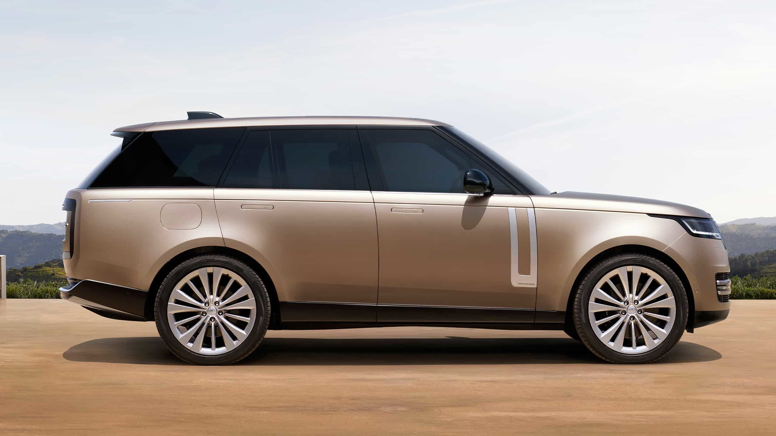Full side view of a bronze Range Rover with silver wheels on a concrete terrace.
