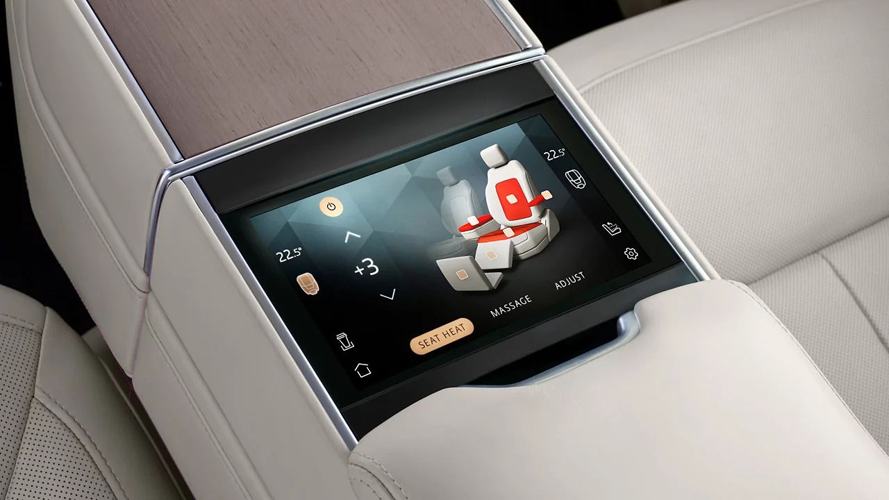 Touchscreen integrated into the rear center armrest for controlling heated seat settings.