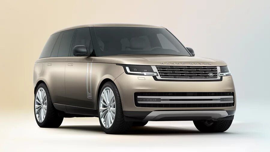 Front three-quarter view of a bronze Range Rover with multi-spoke wheels in a studio.