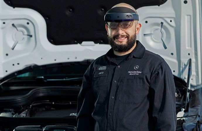 Car engine bay with an augmented reality video call interface overlay.
