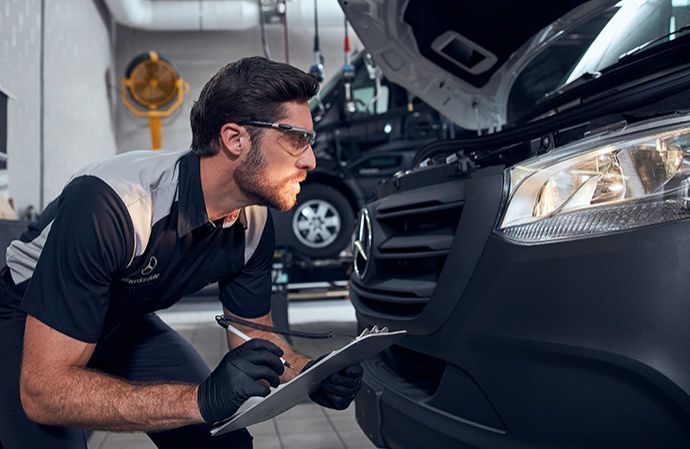 Mercedes-Benz technician inspecting a van