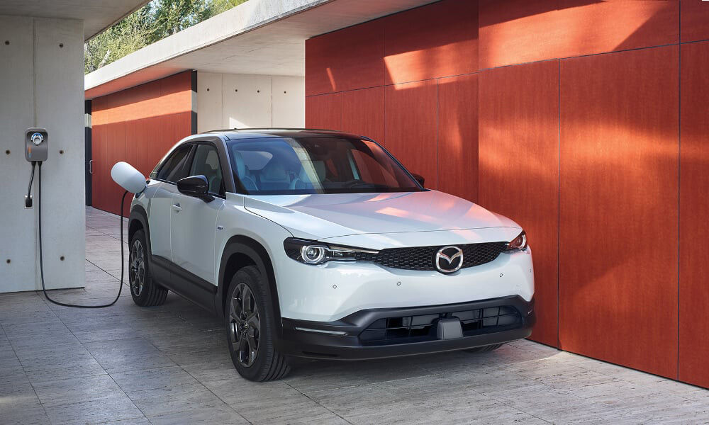 MX-30 EV parked, charging cord plugged in. 