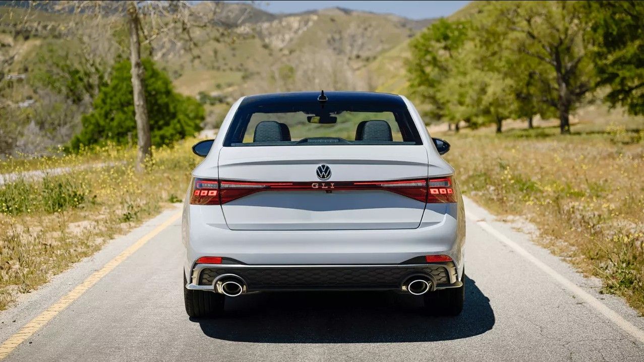 Rear view of the Jetta GLI showing dual exhaust, GLI badge, and full-width taillights.