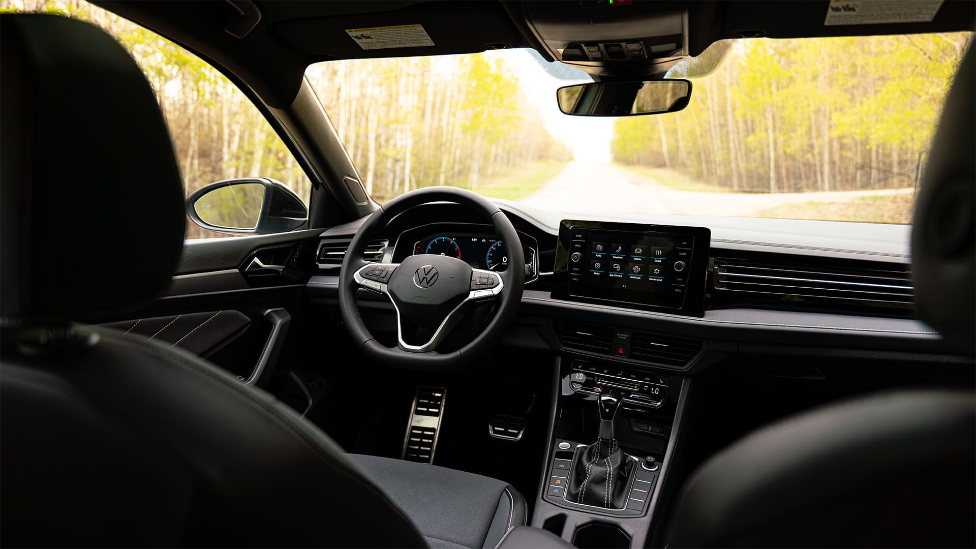 2027 Volkswagen Jetta interior featuring dual digital displays, sport seats, and premium dashboard design