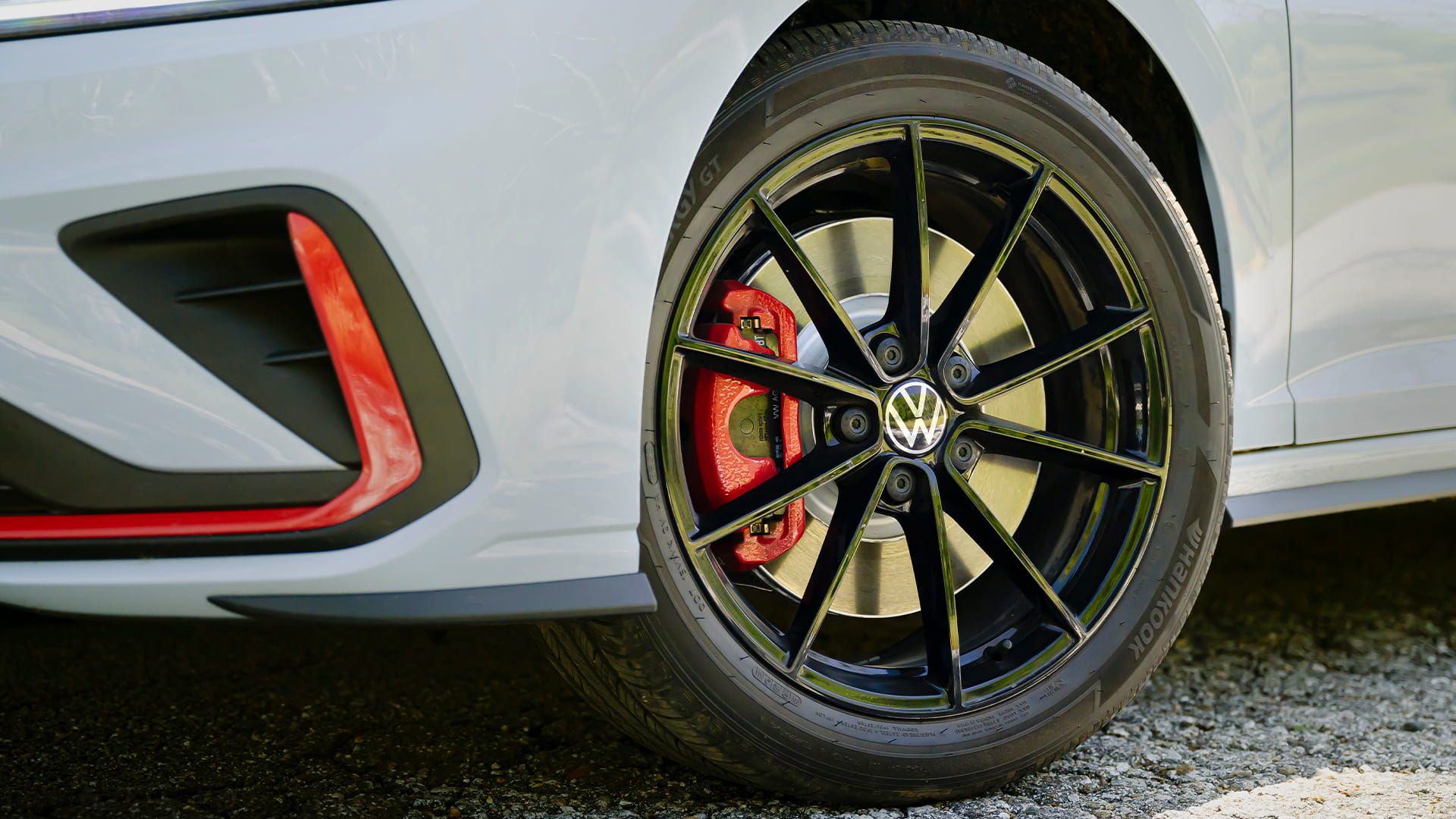 Black alloy wheel on the Jetta GLI with red brake caliper and performance design.