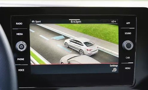 Volkswagen IQ.DRIVE safety system display showing lane assist, adaptive cruise control, and pedestrian detection in action.
