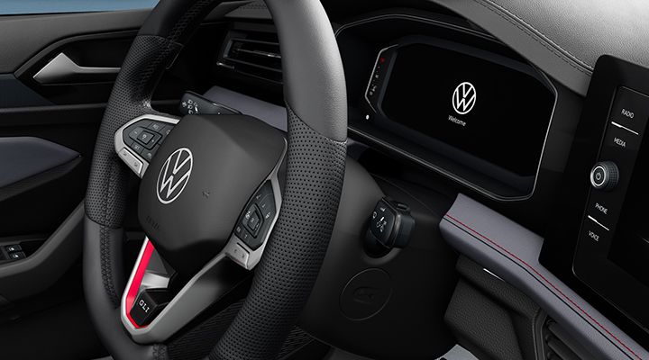 Close-up of the VW Jetta GLI steering wheel and digital cockpit, highlighting the vehicle's dashboard and controls.