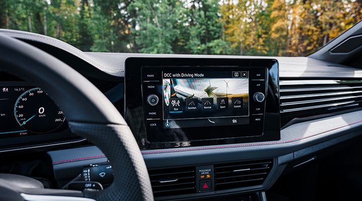 Interior display of the 2026 Jetta GLI showing the DCC system with driving mode options on the central touchscreen.
