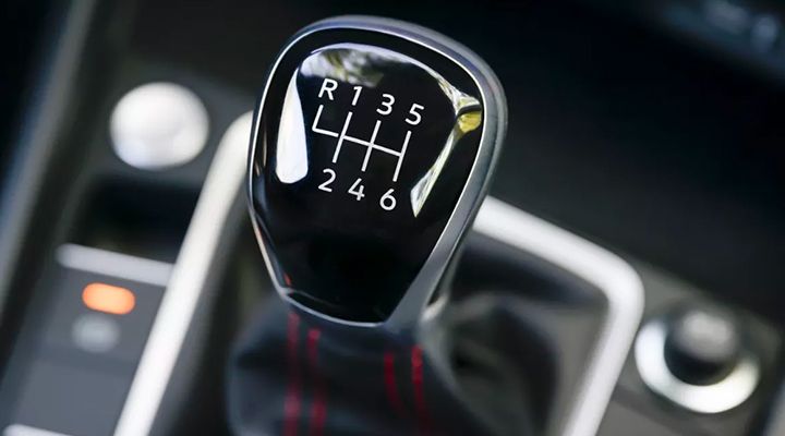 Close-up of a Jetta GLI manual gear shifter with a 6-speed pattern.