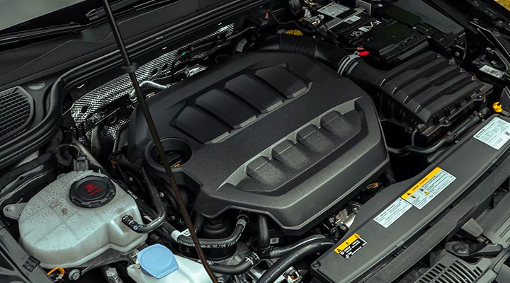 Close-up, overhead view of the engine compartment under the hood of a Volkswagen.