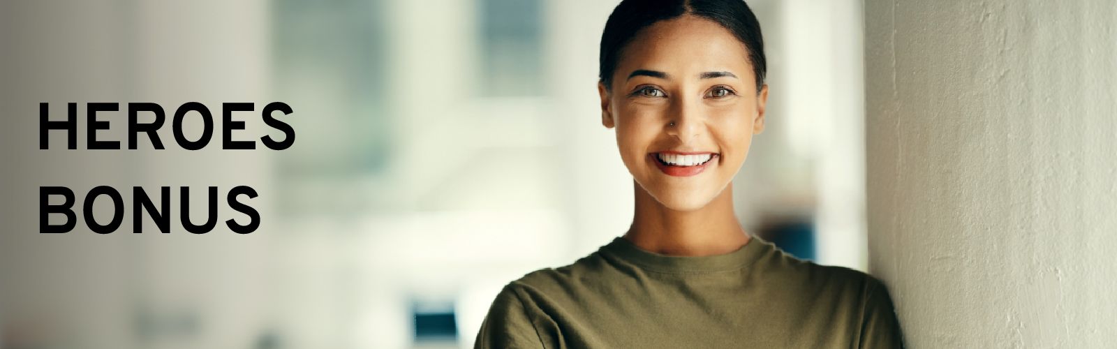 Smiling woman in a military or service uniform shirt, with the text "HEROES BONUS" overlayed.