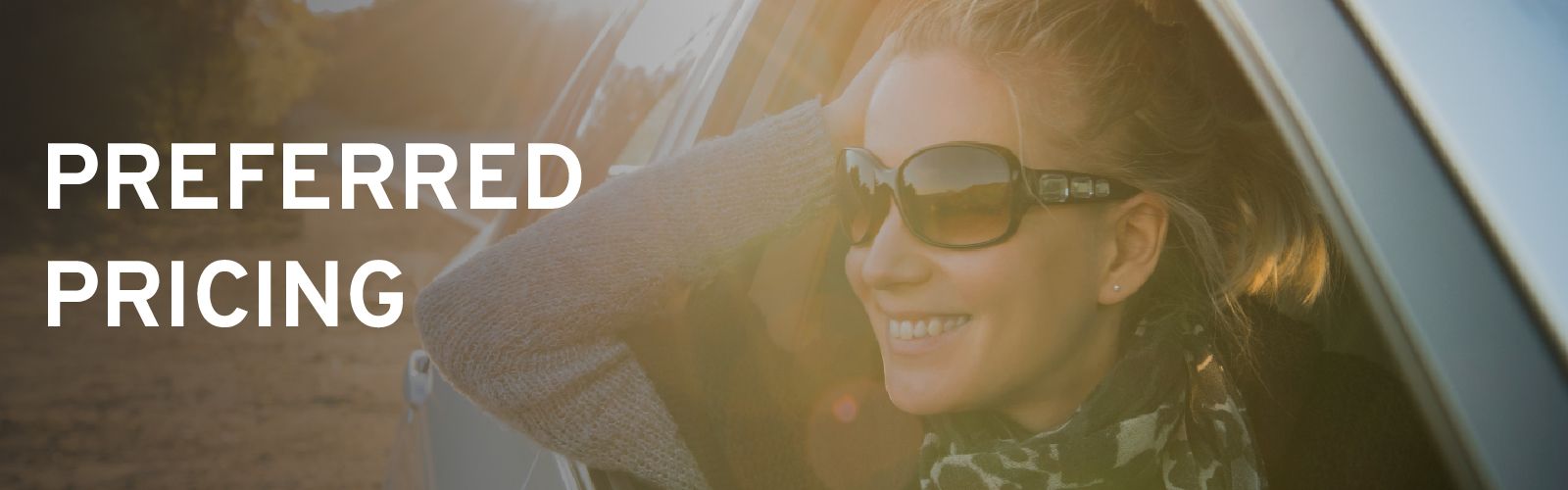 Smiling woman wearing sunglasses with her head and arm out of a car window, with the text "PREFERRED PRICING" overlayed.
