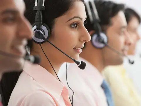 Call center agents wearing headsets at work