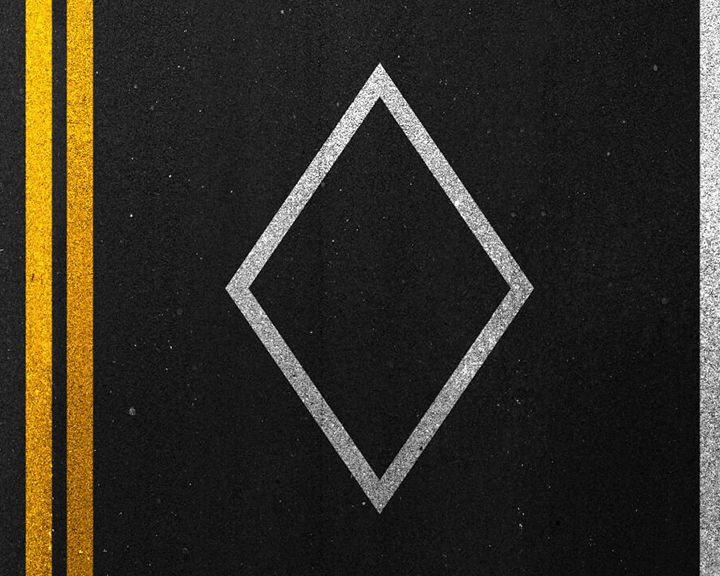 View from slightly above highway asphalt featuring yellow painted lines and HOV diamond. 