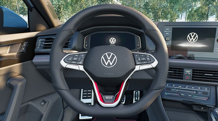 Heated steering wheel of the 2026 Jetta GLI with red stitching and integrated controls.