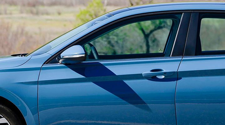 Close-up of the VW Jetta's driver-side door, highlighting the KESSY keyless access feature with a push-start button.