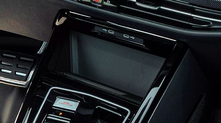 Top-down view of the vehicle's wireless charging pad area, featuring the "Engine Start/Stop" button and two USB-C ports above it.