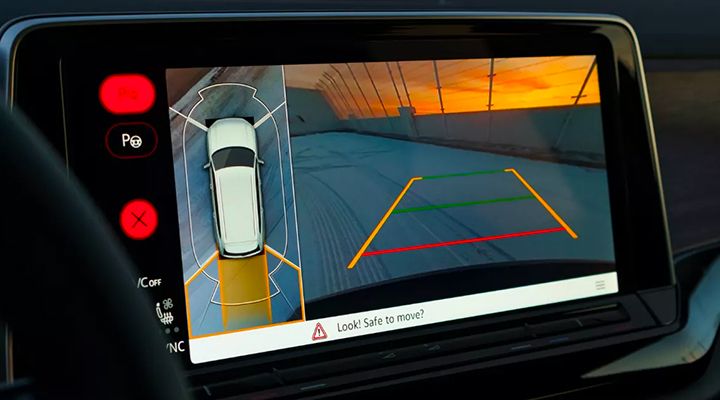 Infotainment screen showing the reverse camera view with dynamic guidelines and the Park Assist sensor display.