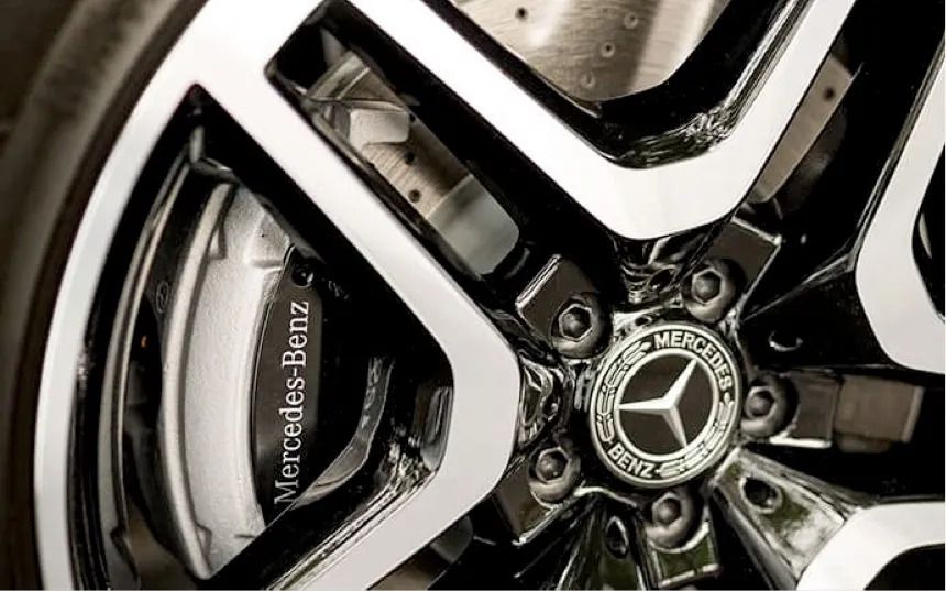 Close-up of a black and silver alloy wheel rim and a Mercedes-Benz brake caliper.
